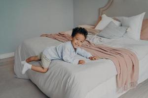 Happy little afro american kid enjoying playtime at home photo