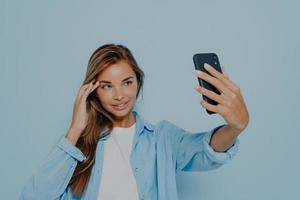 Gorgeous model making selfie on mobile phone photo
