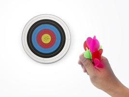 Human hand is throwing the darts target to the darts board. a man's hand throws a dart at the target photo