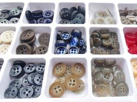 colorful buttons for handicrafts in box isolated on white photo