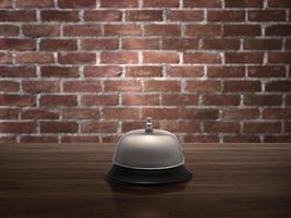 Hotel service bell on wood counter red brick wall background photo