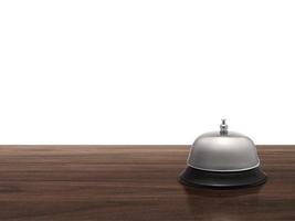 Hotel service bell on wood counter isolated on white background photo