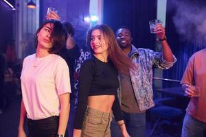 Enjoying free time in the night club. Group of friends having fun together photo