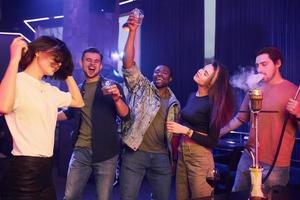 Enjoying free time in the night club. Group of friends having fun together photo