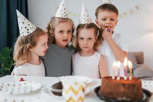 Celebrating brithday. Group of children is together at home at daytime photo