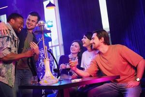 Weekend relax. Group of friends having fun in the night club together photo