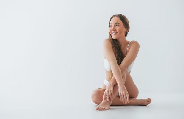 Holding panties by hand. Particle view of hot slim body type of girl that  stands in the room 15197296 Stock Photo at Vecteezy