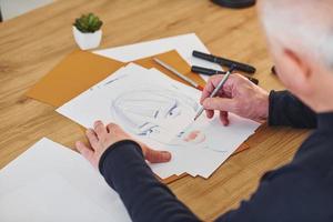 Close up view of painter that working on the sketch of a man photo