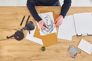 Top view of painter that working on the sketch of a man photo