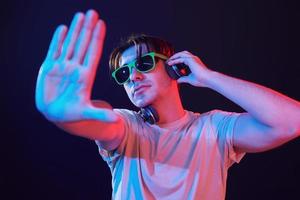 Man standing in the studio with neon light photo