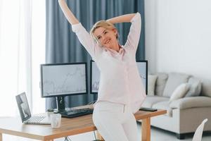 Happy look. Female stock broker in formal wear is working in the office photo