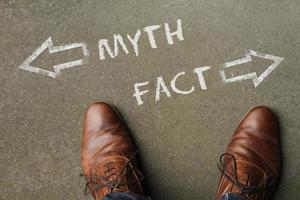 Man standing in front of two arrows and the words Myth and Fact photo