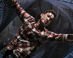 Entangled - a man spreads his arm in a net photo