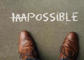 Making the impossible possible - the word impossible with the first two letters crossed out photo