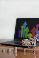 Success in Online Shopping - Trolley and Laptop photo