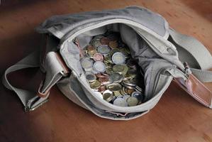 A messenger bag filled with cash photo