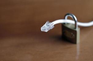 Network protection and secure access - network cable going through a padlock photo