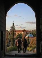 28 September 2018 - Byblos, Lebanon - A couple walks out of the castle in Byblos, Lebanon, before sunset photo