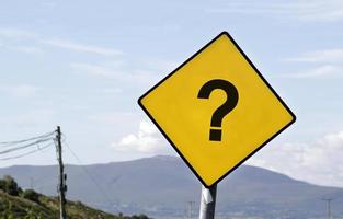 Yellow road sign with a question mark photo