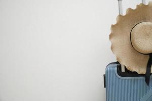 luggage with a wide brimmed hat photo