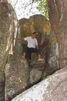 Man on a rocky crevice. photo