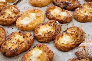 Tasty just baked buns with cottage cheese on the bakery counter photo