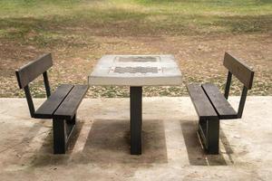 Chess table with benches in the park photo