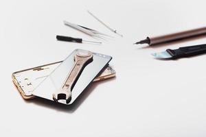 Flat lay image of dismantling the broken smart phone for preparing to repair or replace some components. isolated photo