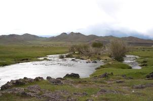 View of a river sorrounded by a green landscape in central Mongolia. photo