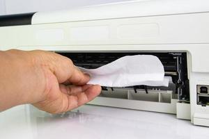 Technicians Removing Paper Stuck, Paper Jam In Printer At Office photo