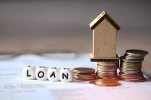 Home loan concept, Loan word on table with loan house model economy commercial real estate, Banks approve loans to buy homes business finance investments concept photo