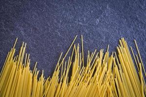 raw spaghetti italian pasta uncooked spaghetti yellow long ready to cook in the restaurant italian food and menu photo