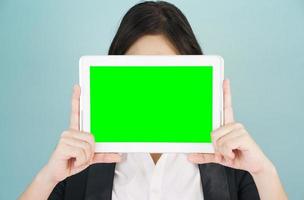 Young women in suit holding her digital tablet mock up photo