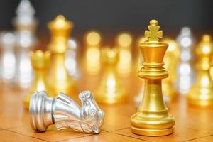 Gold king chess and horse piece on wood chessboard photo