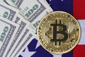 Close up Gold Bitcoin coin and banknote on usa flag photo