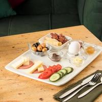 A closeup shot of a breakfast white plate on a wooden table photo