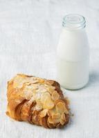 Fresh croissants bread and a cup of coffee on fabric. French breakfast. photo