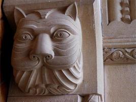 Cat's head carved on a column photo