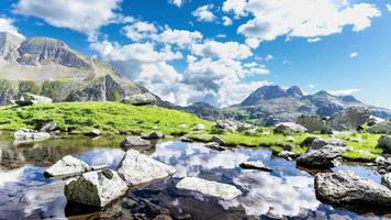 Time-laspe of a small mountain lake with moving clouds video