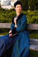 Portrait of woman dressed in blue historical Baroque clothes with old fashion hairstyle, outdoors. photo