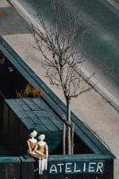 Ortisei, South Tyrol, Italy, 2016. Two Mannequins on a Wall in Ortisei photo