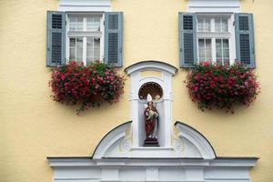 St Wolfgang, Austria, 2017. Statue of a Bishop on a Wall in St Wolfgang photo
