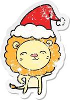 distressed sticker cartoon of a lion wearing santa hat vector