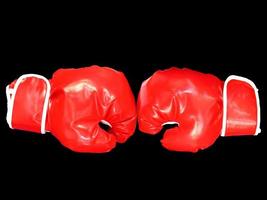 Red boxing gloves on black background. photo