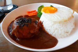 Pork burger in japanese curry sauce served with rice and fried egg. photo