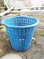 Light blue waste basket made of plastic photo