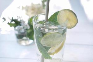 mojito cocktail glass on a white table photo