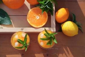 summer orange cocktails and oranges on a table photo