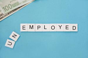 unemployed spelled out in wooden letter tiles photo