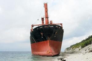 dry cargo ship ran aground near the shore. photo